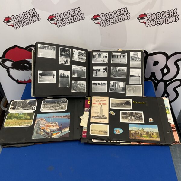 Open vintage photograph album with black and white photos.