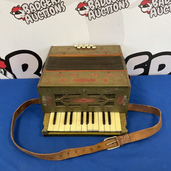 Front view of a vintage Mastertone piano accordion.
