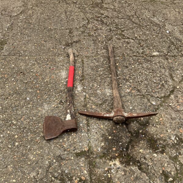 Antique pickaxe tool with axe head for mining or geology.