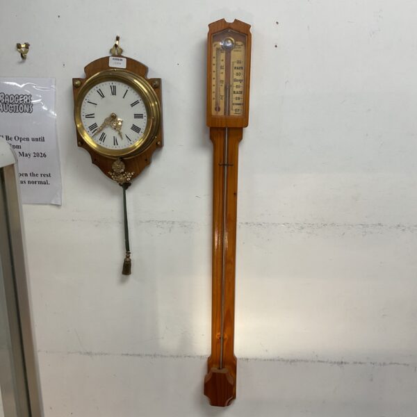 Vintage pine mercury stick barometer for weather forecasting.