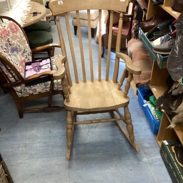 Vintage pine rocking chair with spindle back and curved rockers.
