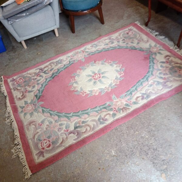 Vintage pink floral rug with shag pile, approximately 6x4 feet.