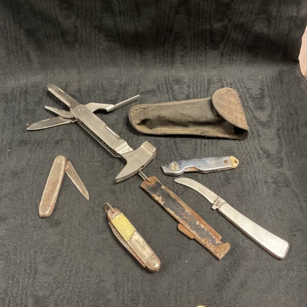 Vintage pocket knife multitool with bone handle and folding blade.