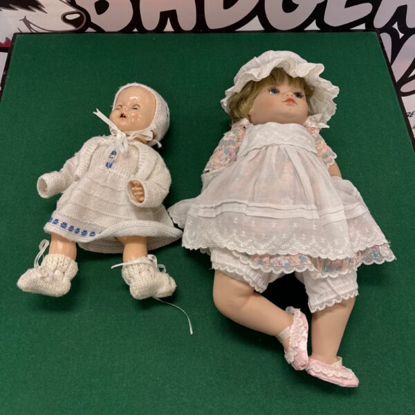 Vintage porcelain dolls in pink dresses, antique doll lot.