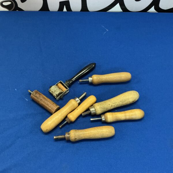 Vintage set of pottery shaping tools with wooden handles.