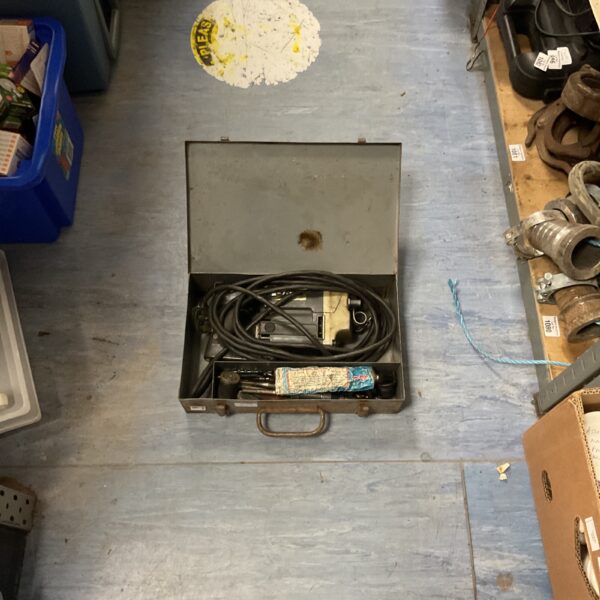 Vintage rotary hammer drill in carrying case, industrial power tool.
