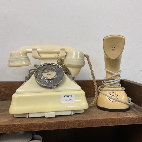 Cream vintage rotary telephone, classic retro design.