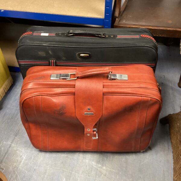Vintage red Samsonite suitcase with Jassia suitcase on display.