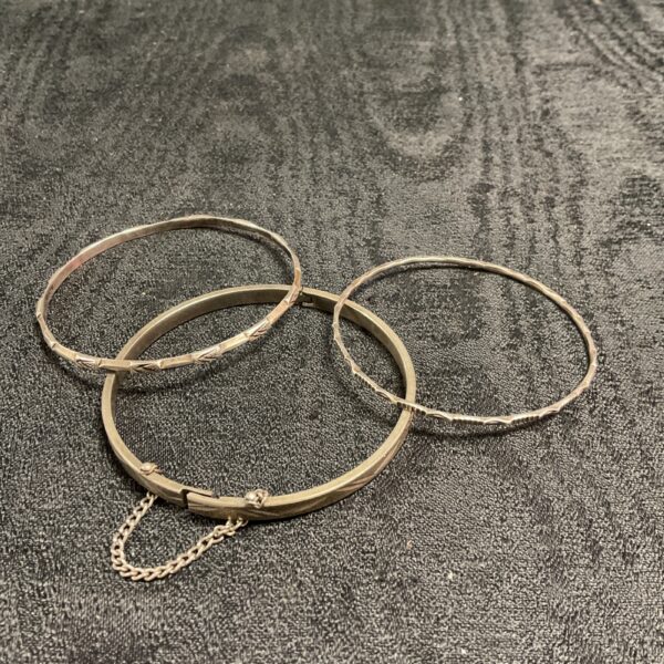 Vintage silver-tone bracelets displayed as a lot.