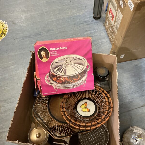Vintage silver plated serving dish on a cardboard box.