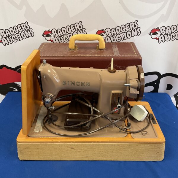 Vintage Singer electric sewing machine in its original case.