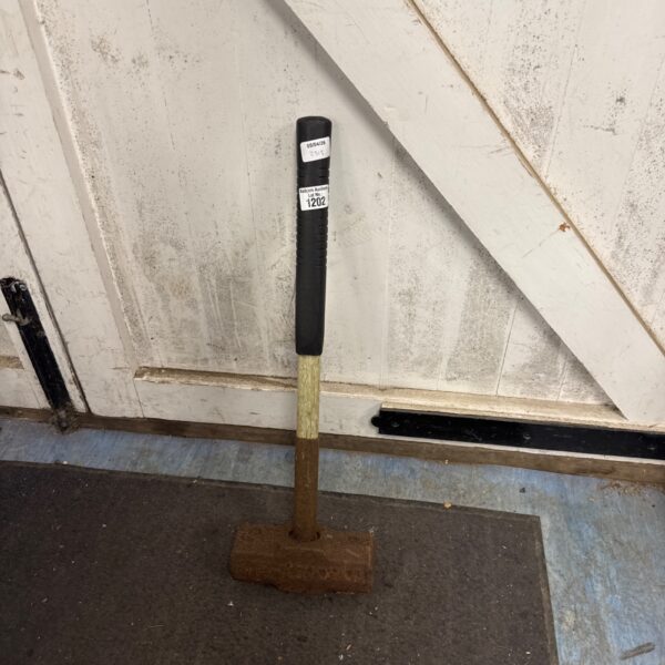 Vintage sledge hammer with a metal head and wooden handle.