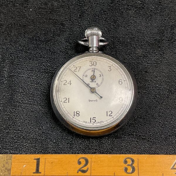 Vintage Smiths stopwatch with white dial and black markings.