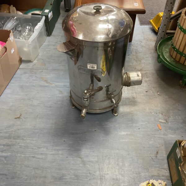 Vintage stainless steel coffee urn with spigot for serving.