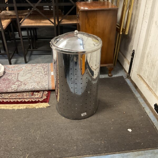Vintage stainless steel laundry basket with perforated sides.