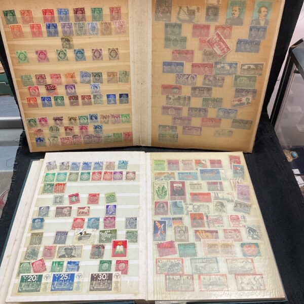 Two vintage stamp albums filled with stamps for collecting.