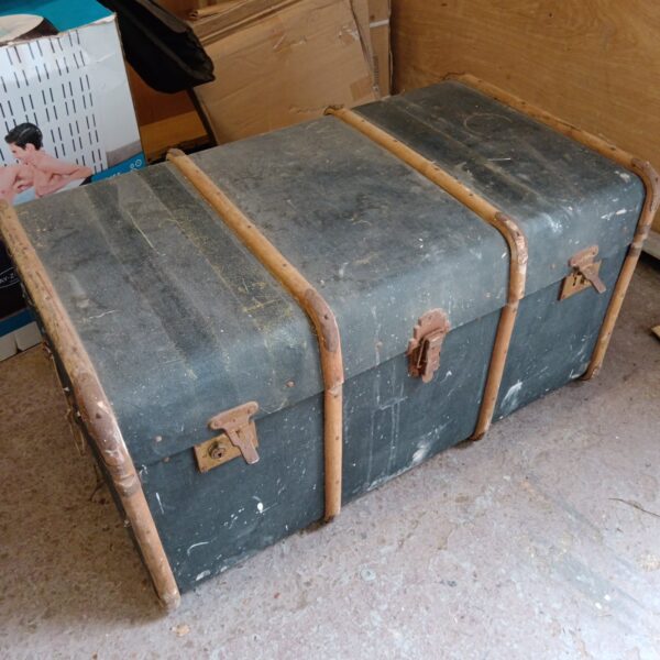 Large vintage steamer trunk with metal corner protectors.