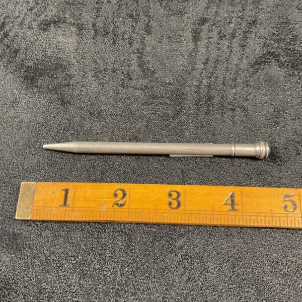 Vintage sterling silver pencil with retractable mechanism, a collectible writing instrument.