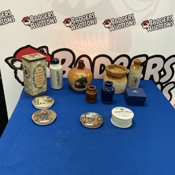 Vintage stoneware bottles and biscuit tin collection for collectors.