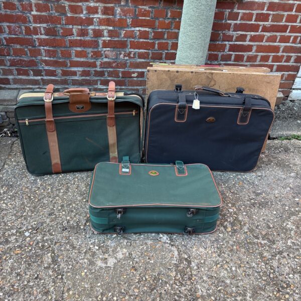 Lot of three vintage suitcases, including Antler and Meridian brands.