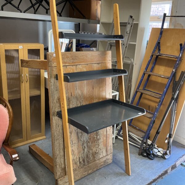 Vintage three-shelf wall unit with wooden ladder back.
