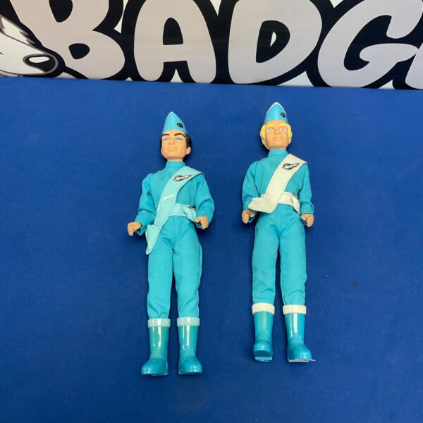 Vintage Thunderbirds figures in blue suits, collectible toys.