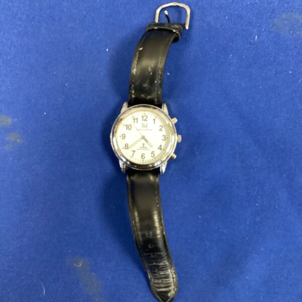 Vintage T&J wristwatch with analogue face and leather strap.