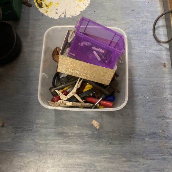 Vintage tool collection in plastic containers, antique hand tools.