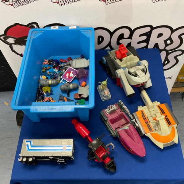 Vintage toy lot with Transformers, He-Man, and Thundercats figures.