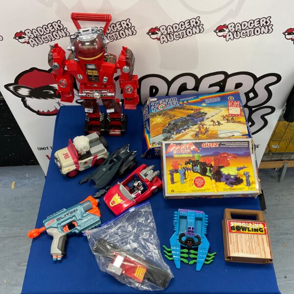 Overview of a vintage toy lot including Matchbox, Gutz, and Transformers.