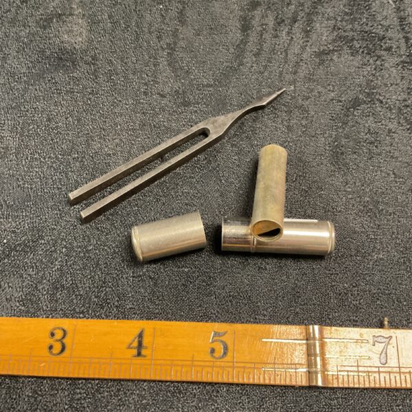 Vintage tuning fork and A-C whistle set for musical tuning.