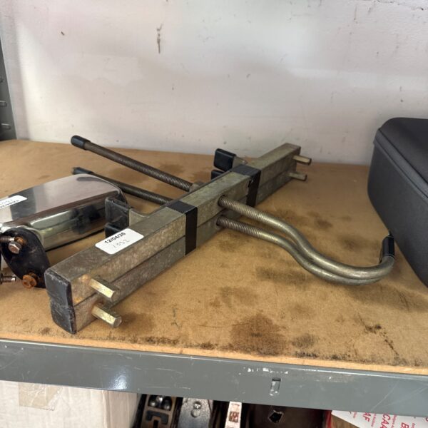 Vintage van ladder racks for securing ladders on vehicle roofs.