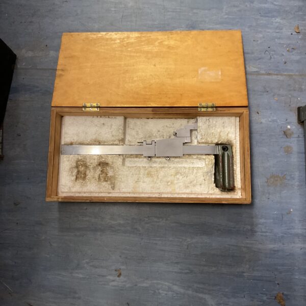 Vintage vernier height gauge in wooden case, precision measuring tool.