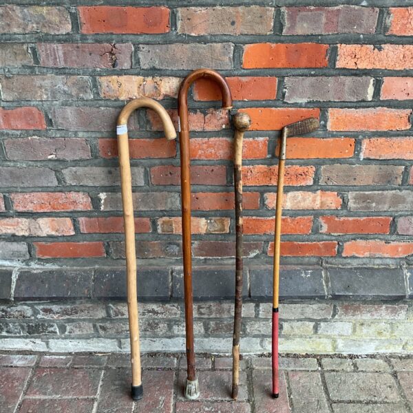 Vintage walking sticks and golf club lot for collectors.