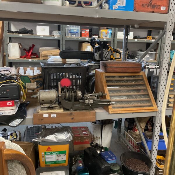 Vintage watchmaker's lathe with haberdashery display cabinet and tooling.