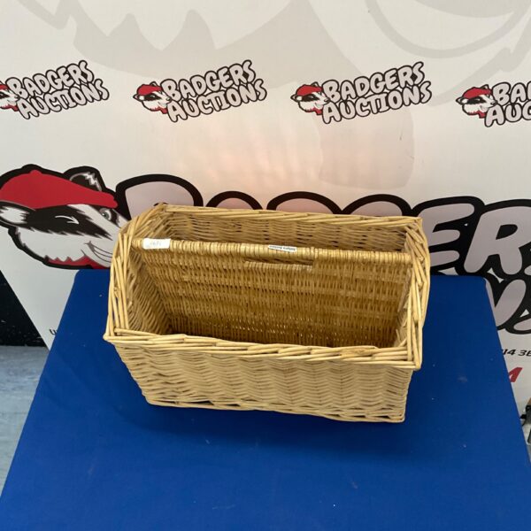 Vintage wicker magazine rack for storing magazines in rustic style.