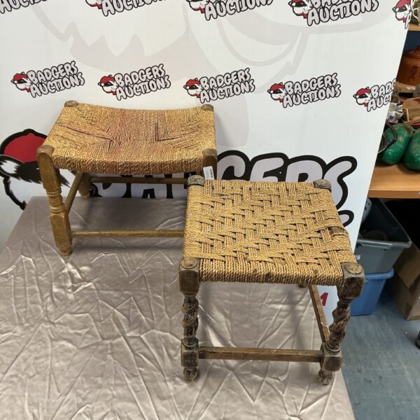 Pair of vintage wicker stools with woven seats and turned legs.