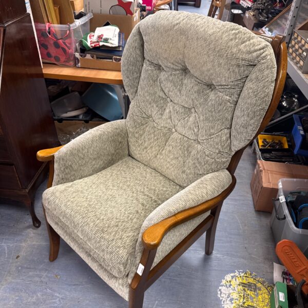 Grey upholstered vintage wingback armchair with wooden frame.