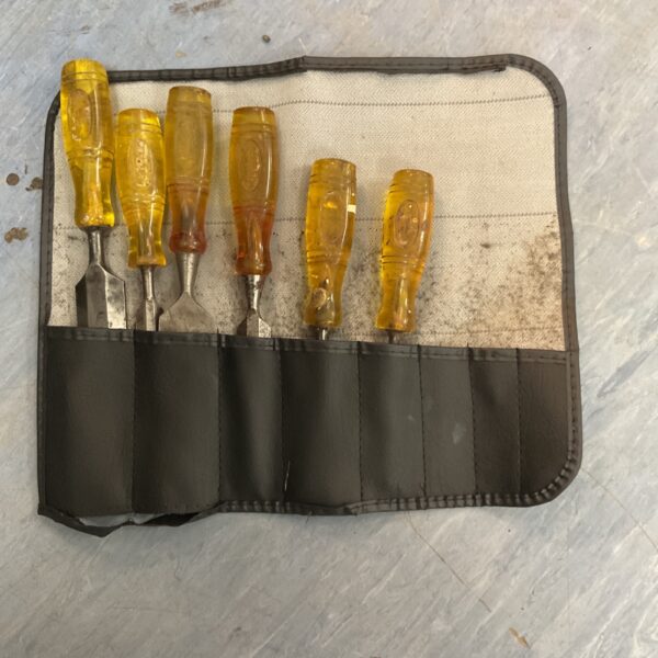 Vintage set of six wood chisels in a canvas pouch.