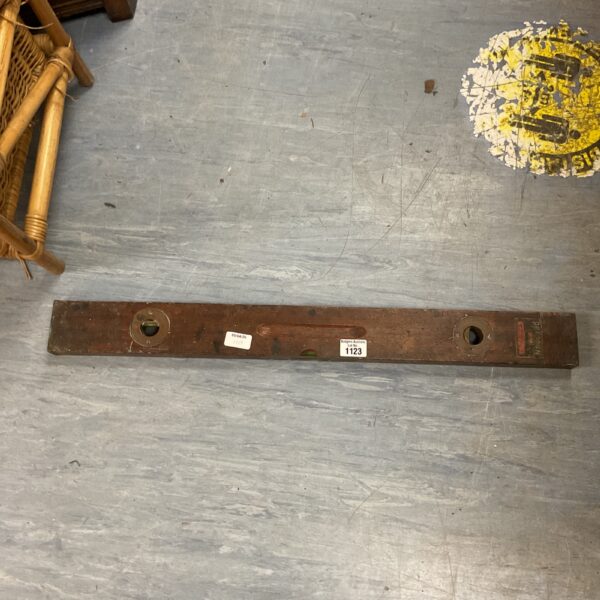 Vintage wooden spirit level with glass vials for accurate leveling.