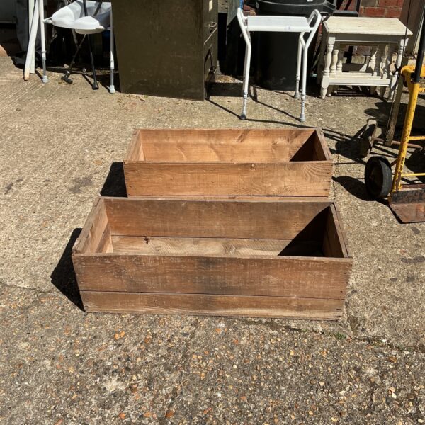 Two vintage wooden storage boxes with weathered timber.