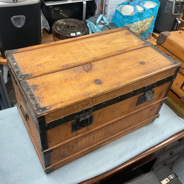 Vintage wooden storage chest with metal clasps and handles.