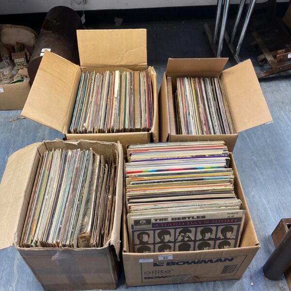 Stack of boxes filled with a large vinyl record collection.