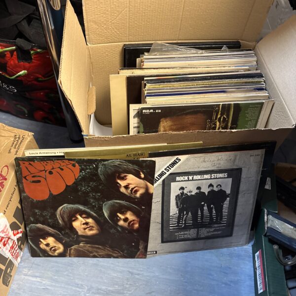 Vintage vinyl record lot featuring Rolling Stones and Beatles albums.