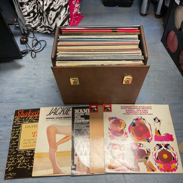 Stack of vintage vinyl records, mixed genre collection.