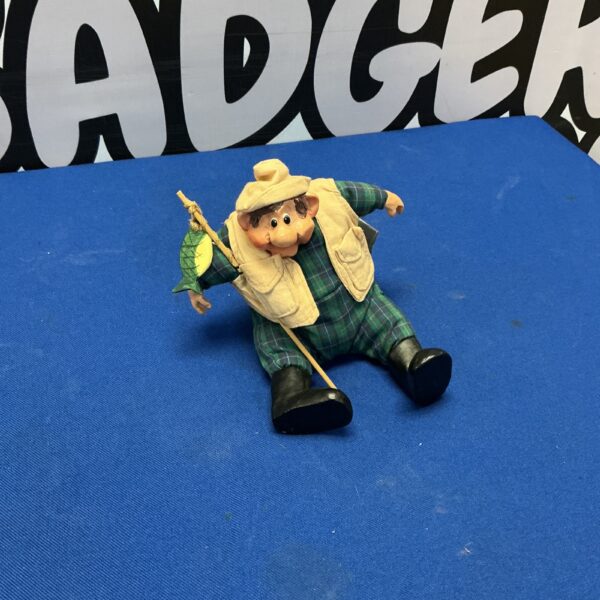 Wade pottery fisherman figure with fishing rod and fish.