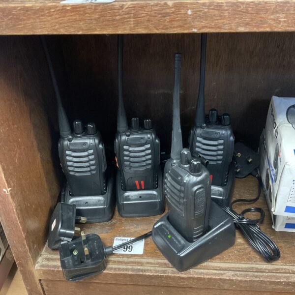 Set of four black walkie talkies for short-range communication.