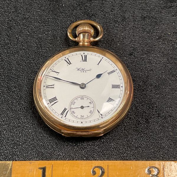 Vintage Waltham Traveller pocket watch with Roman numerals.