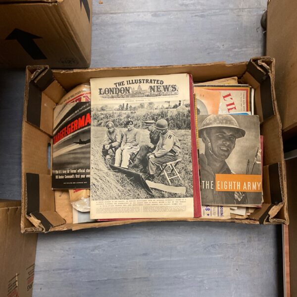 Vintage wartime ephemera lot featuring old magazines and newspapers.