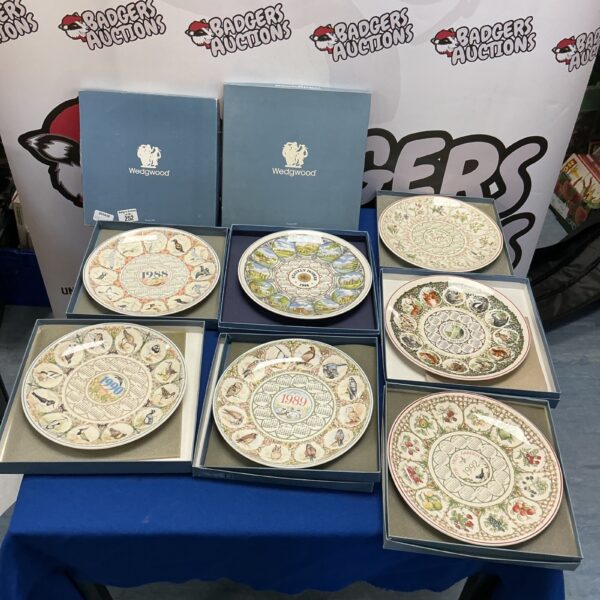 Collection of Wedgwood calendar plates displayed for auction.